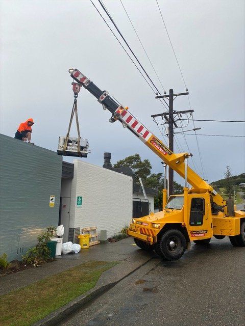 Crane installing a refrigeration system