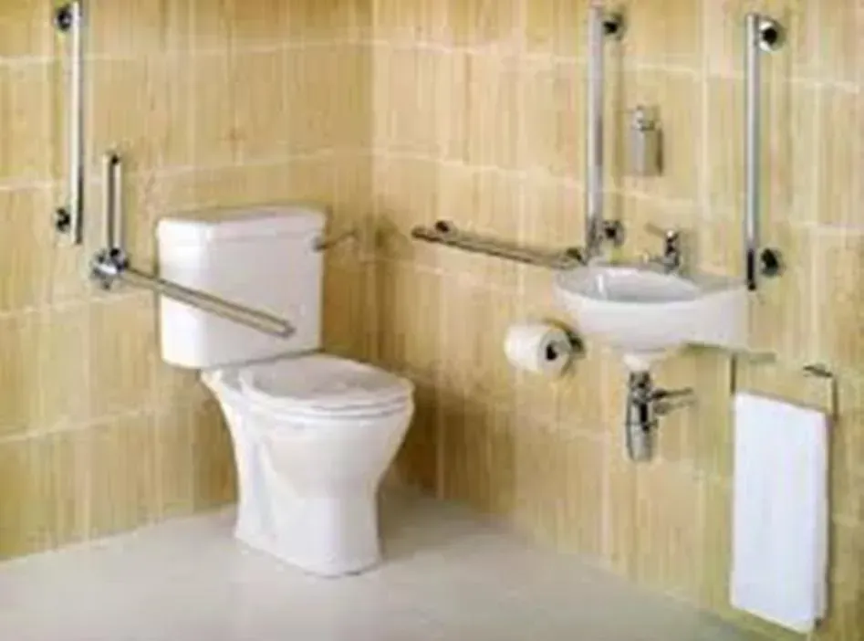 A Bathroom With A Toilet , Sink , And Handrails — Laredo, TX — South Central Hardware Inc.