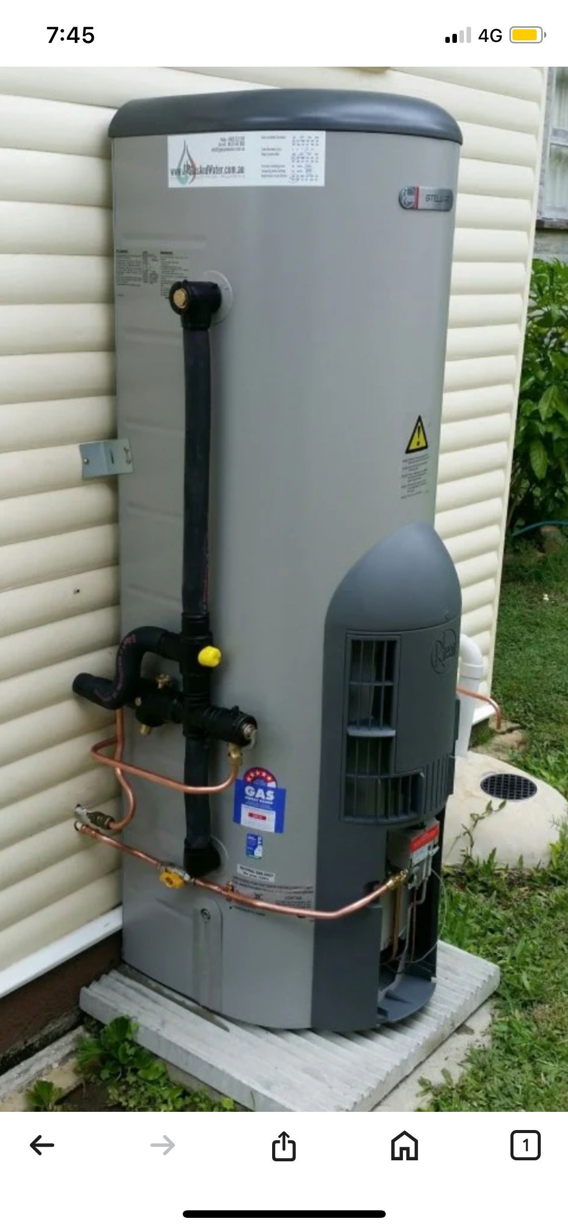 A Grey Water Heater is Attached to a Brick Wall — Corbett Plumbing in Ballarat, VIC