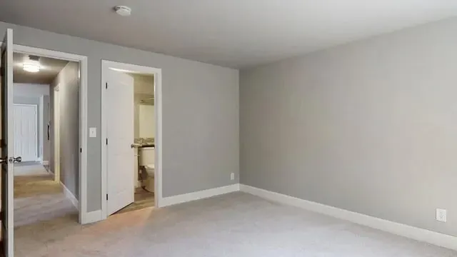Bedroom with doorway to hallway and bathroom