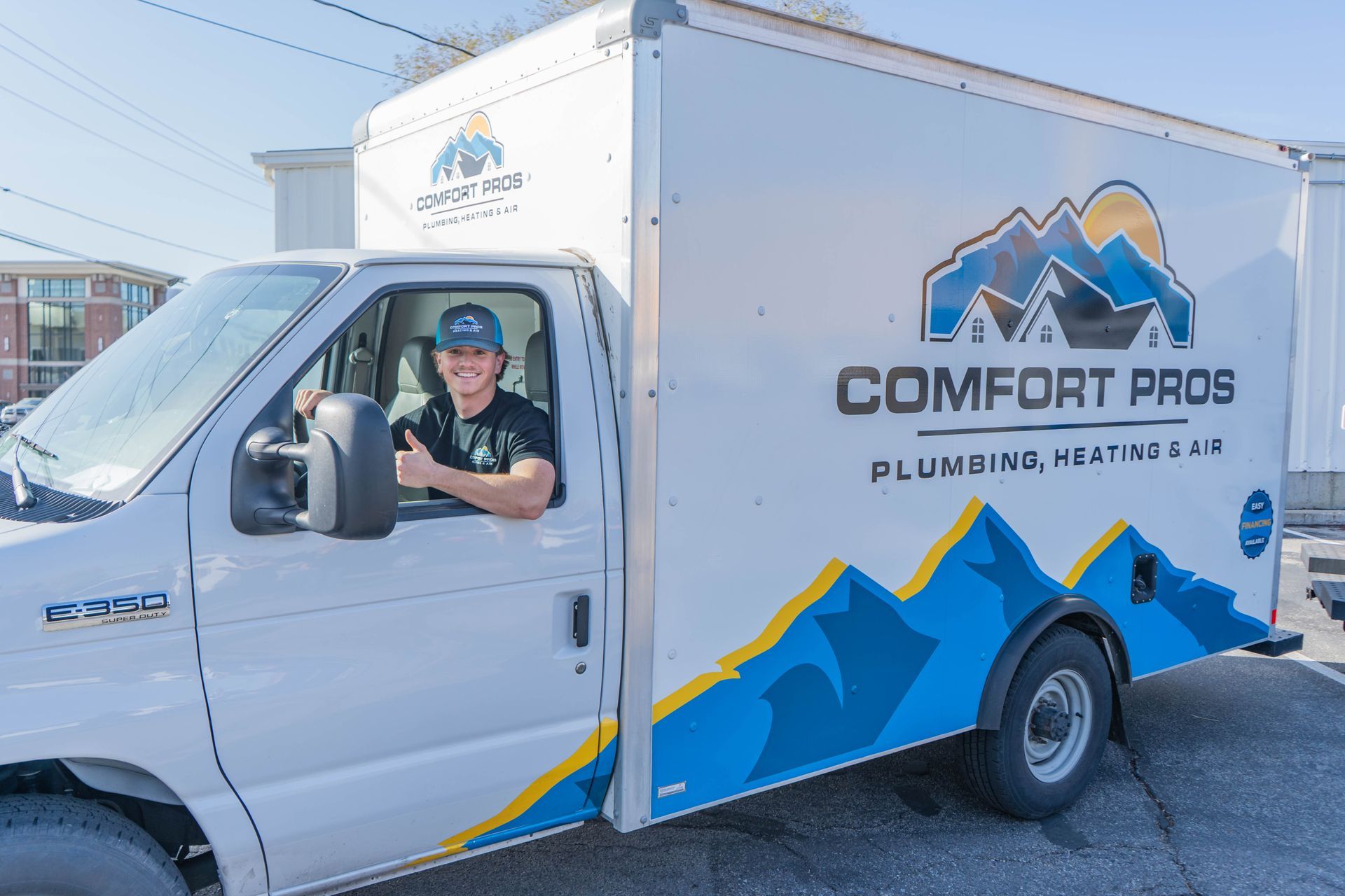 A family is sitting on the steps of their house.