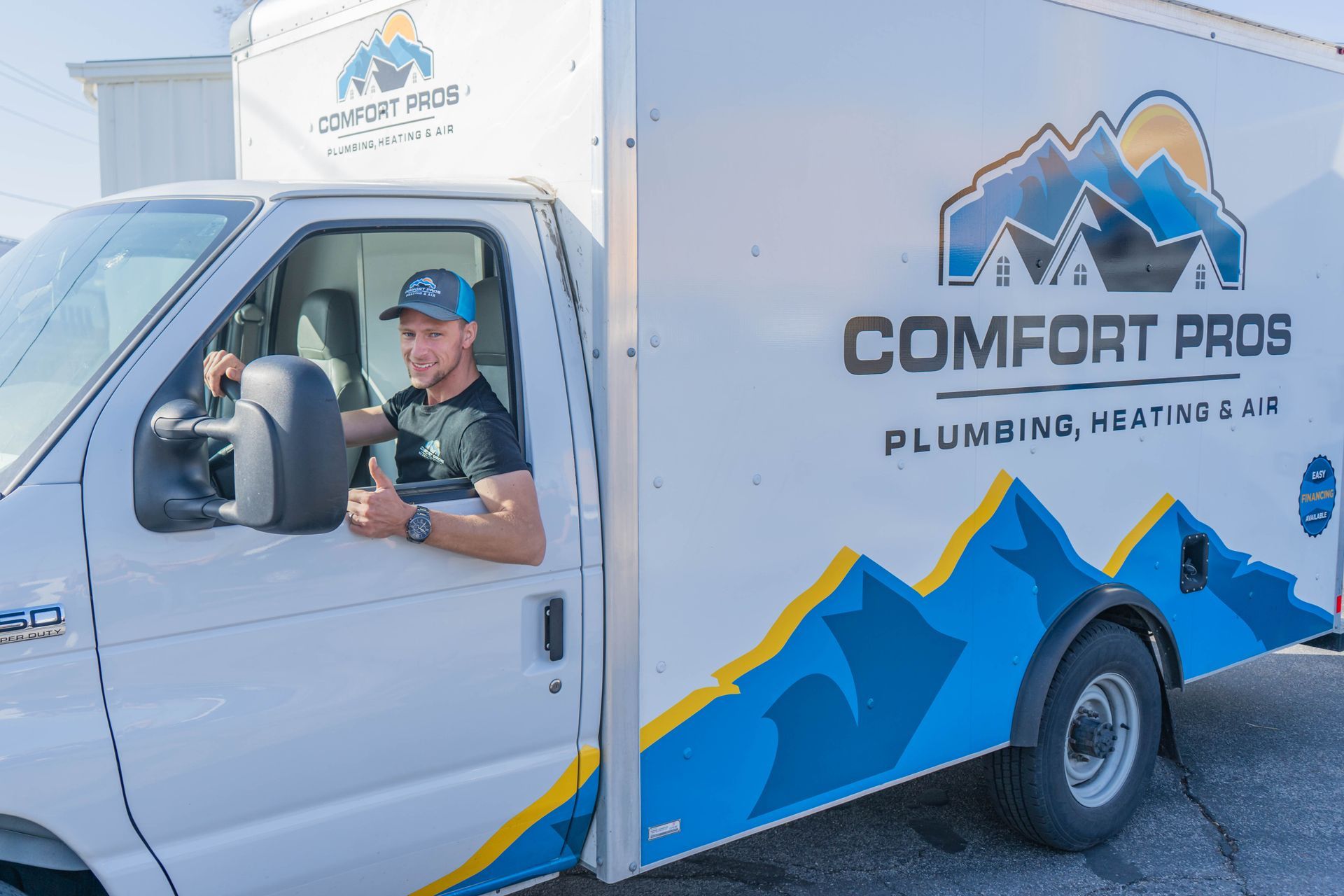 A person is working on a pipe with a wrench.