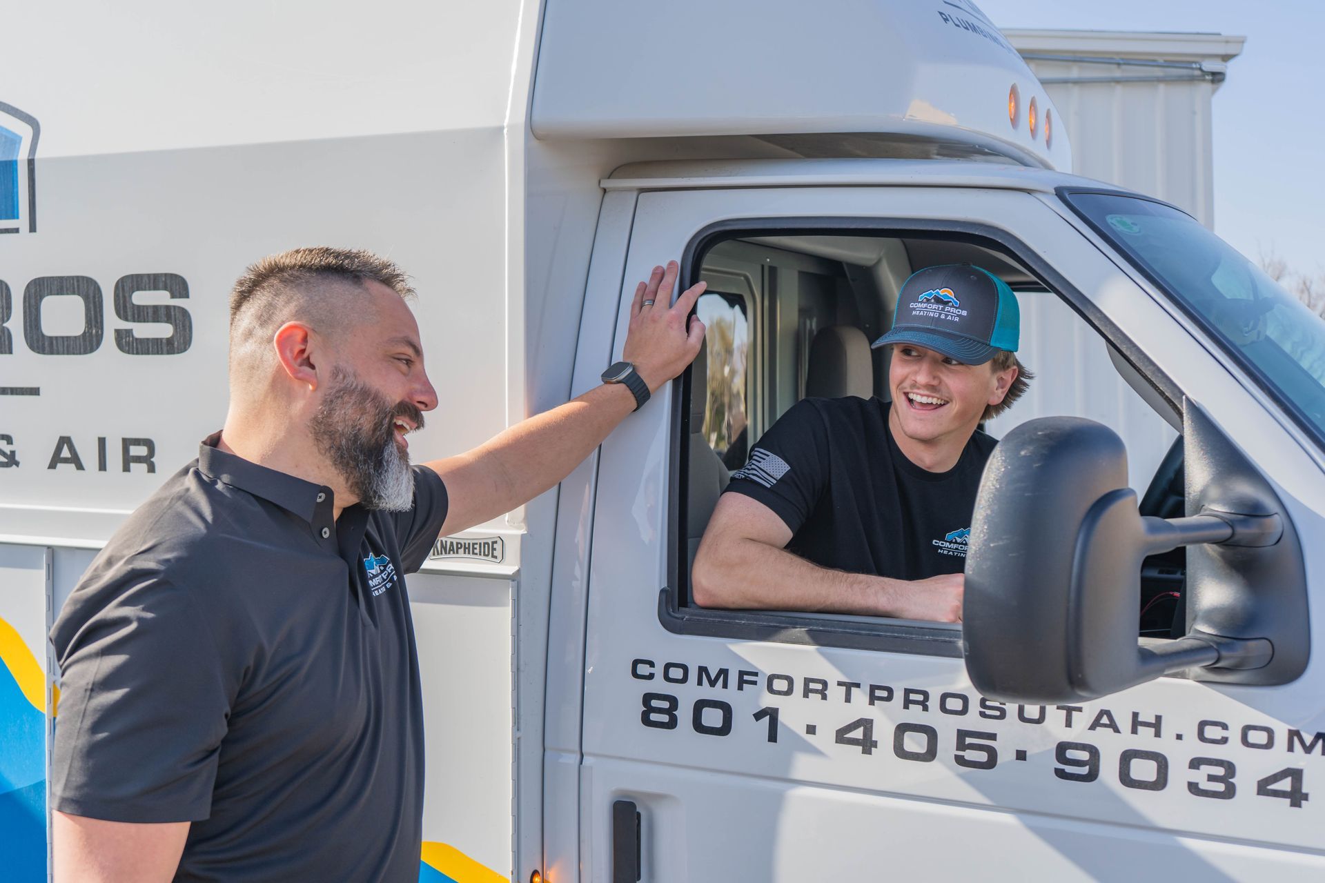 A man wearing safety glasses and gloves is working on a machine.