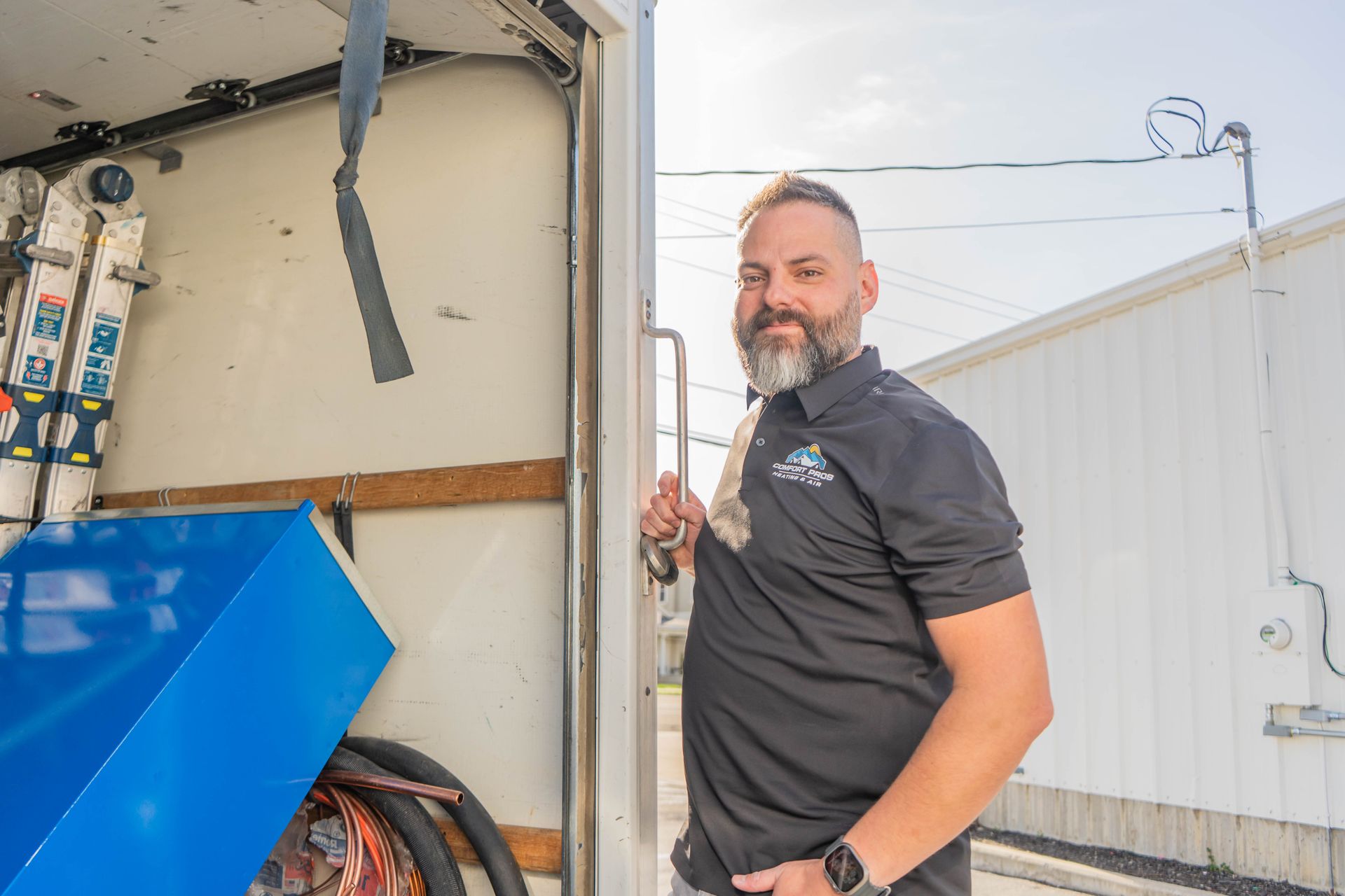 A family is sitting on a couch laughing together.