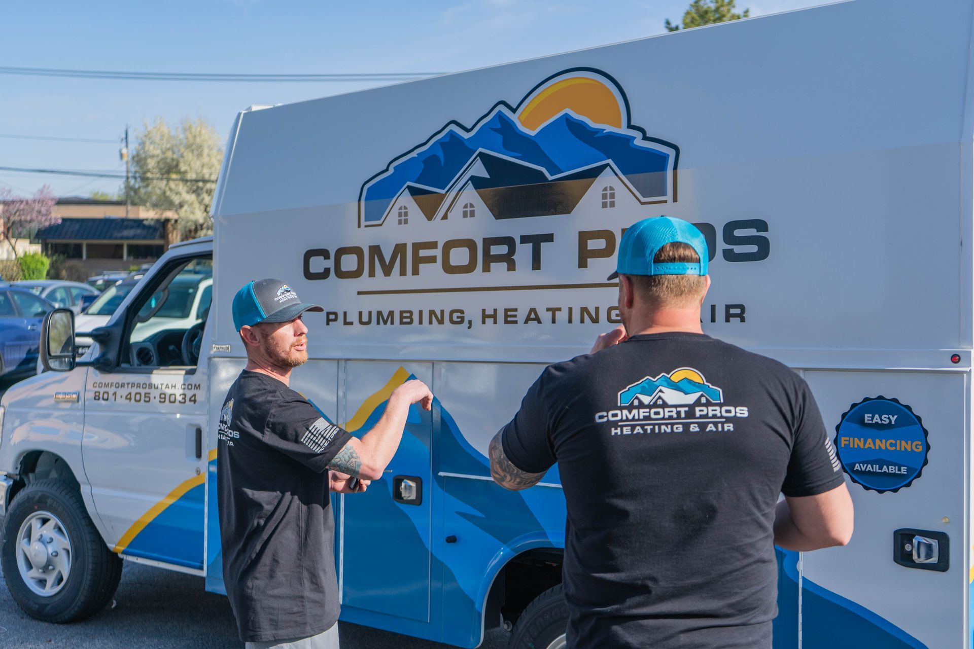 A plumber is fixing a sink in a kitchen.