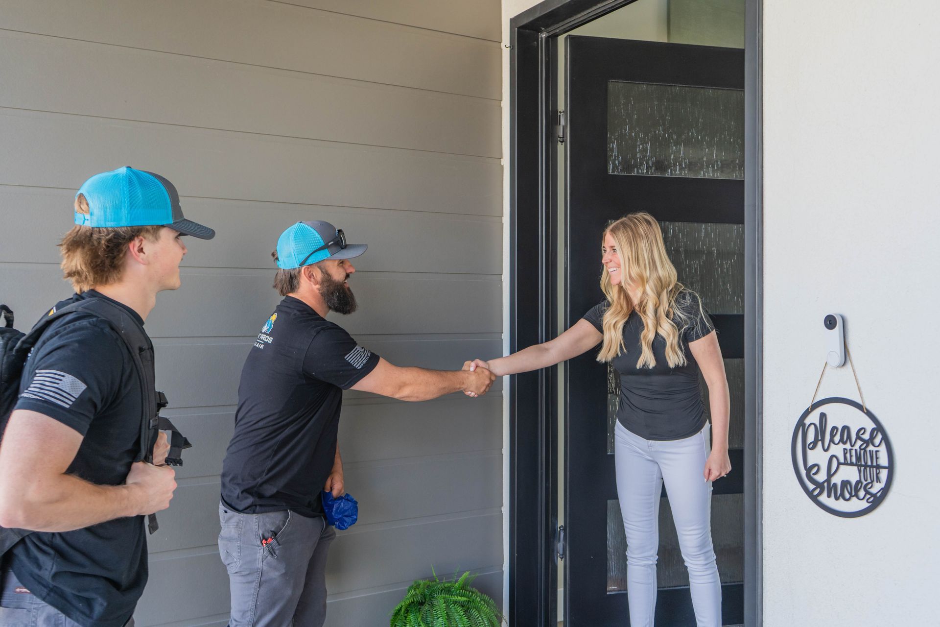 A woman is washing her hands in a bathroom sink.