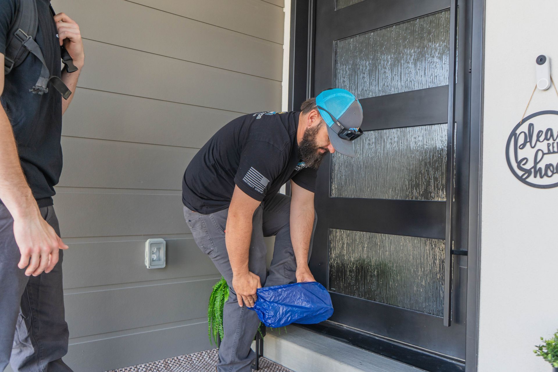 A family is sitting on the steps of their house.