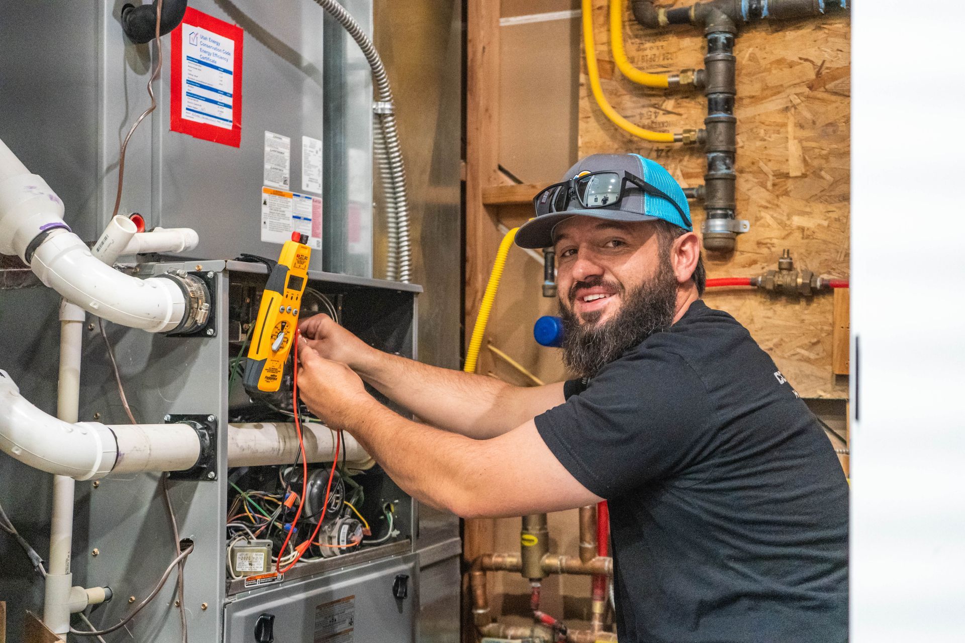 A person is fixing a pipe with a wrench.