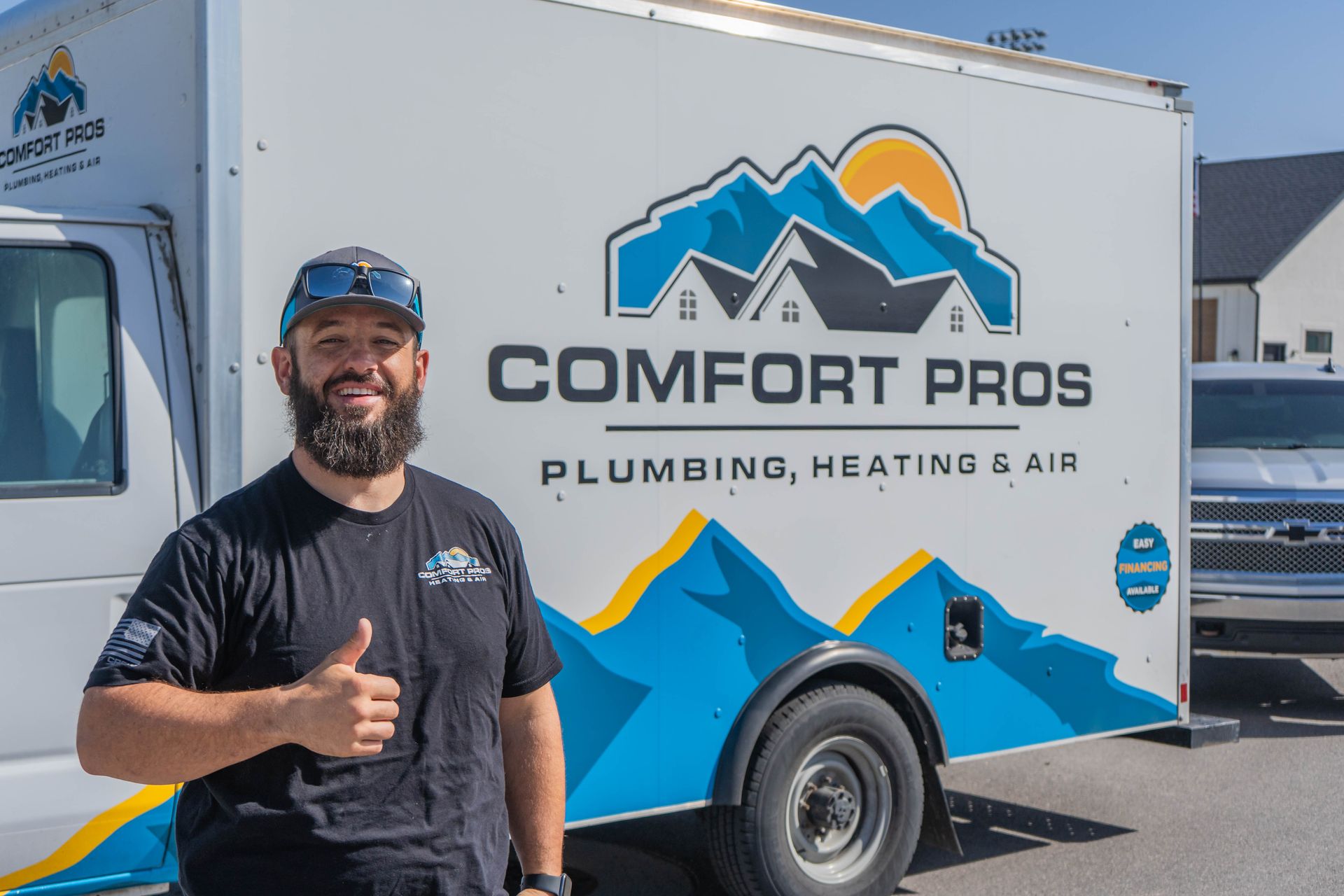A woman is adjusting a thermostat with a smart phone.