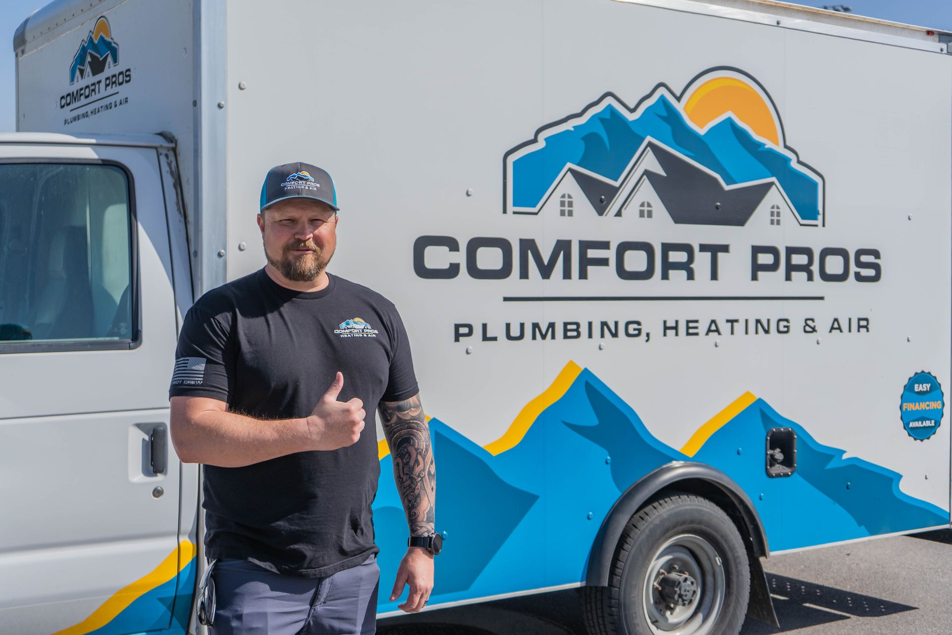 Two men are working on an air conditioner outside of a building.