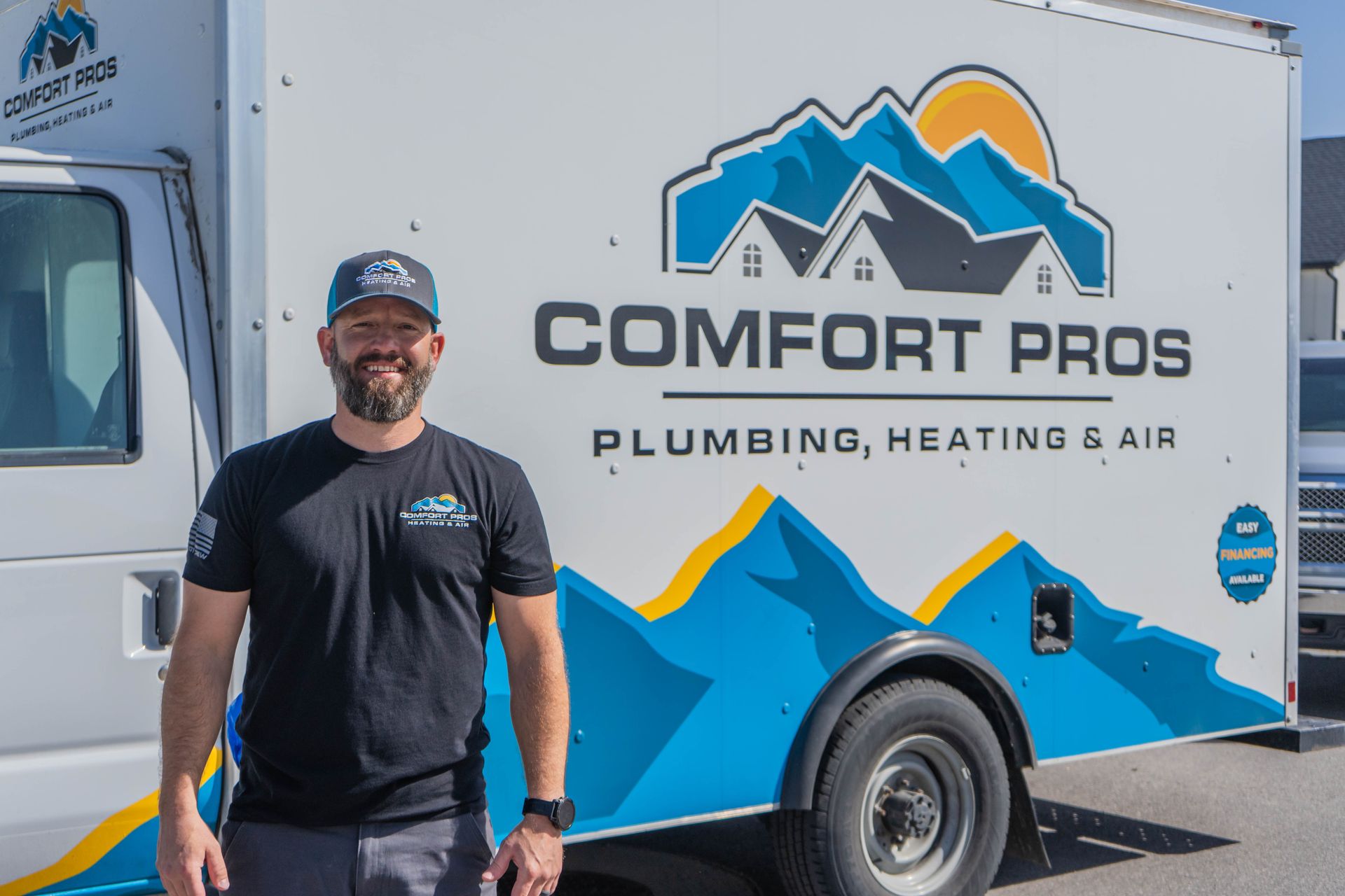 A family is sitting on a couch with a laptop.