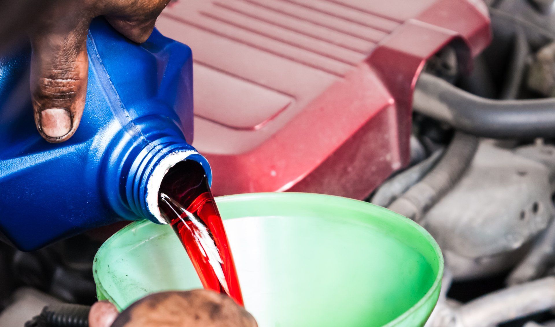 Man pouring transmission fluid into funnel | Eagle Transmission & Auto Repair - Mesquite