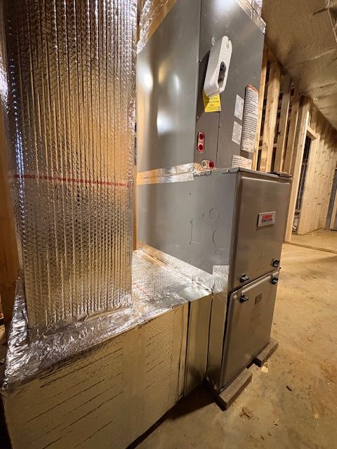 A large house with a blue roof is sitting on top of a lush green lawn.