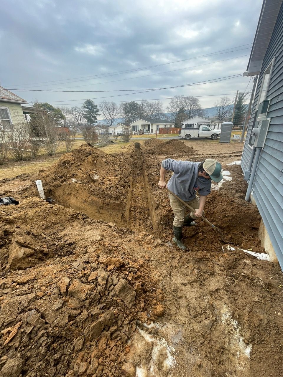An aerial view of a large brick house surrounded by trees and grass.