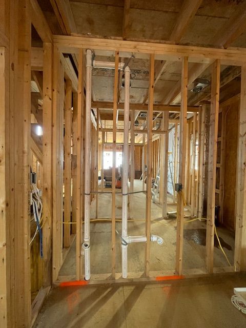 A large house with a blue roof is sitting on top of a lush green lawn.