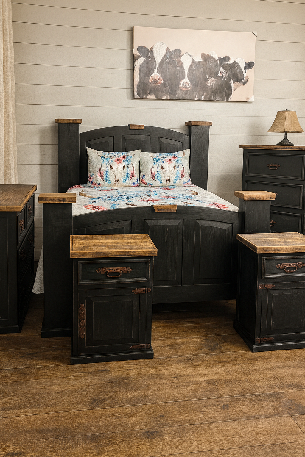Bedroom with black wooden furniture and cow artwork.