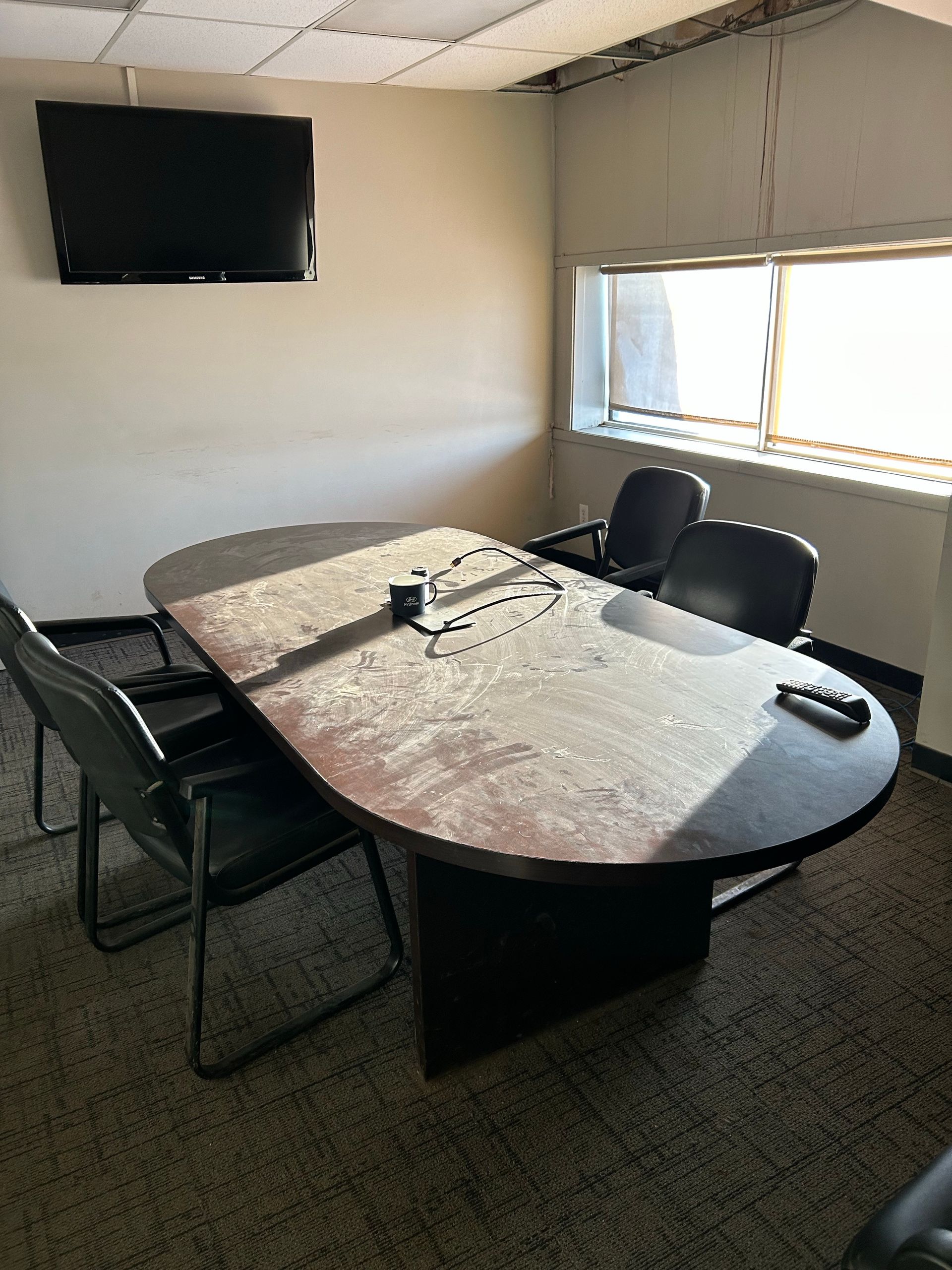 A conference room with a large table and chairs