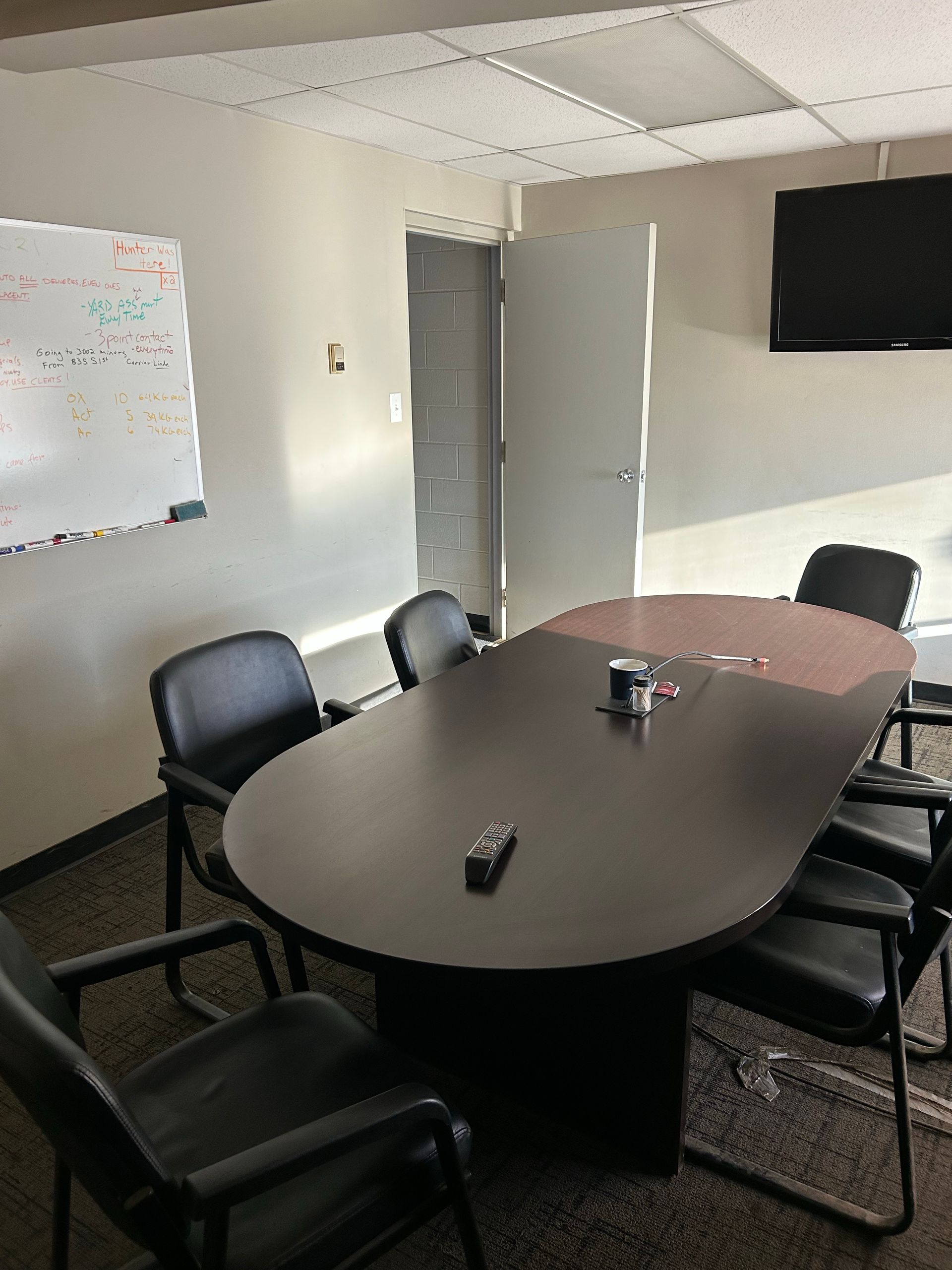 A conference room with a long table and chairs