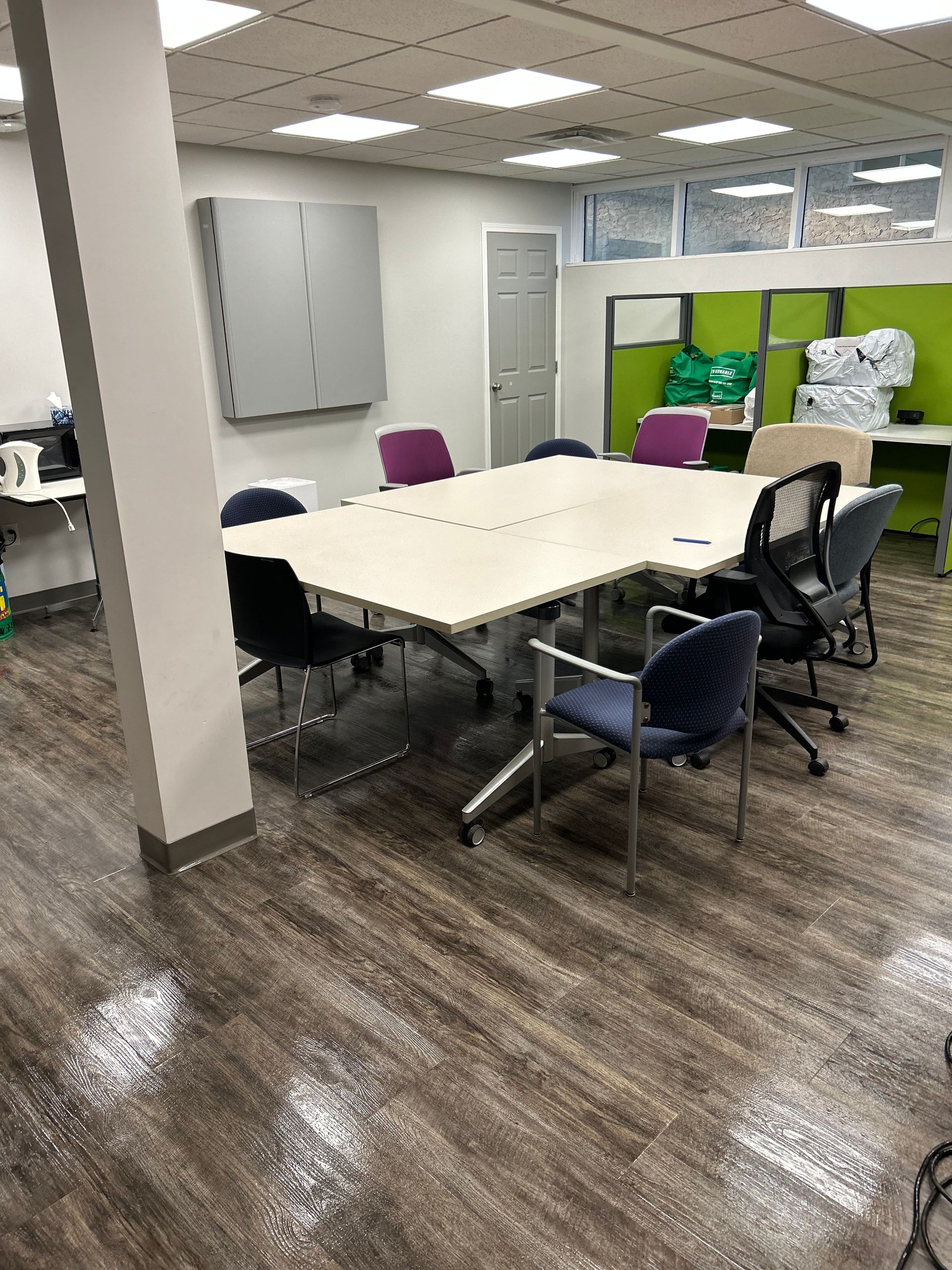 A conference room with a table and chairs in it
