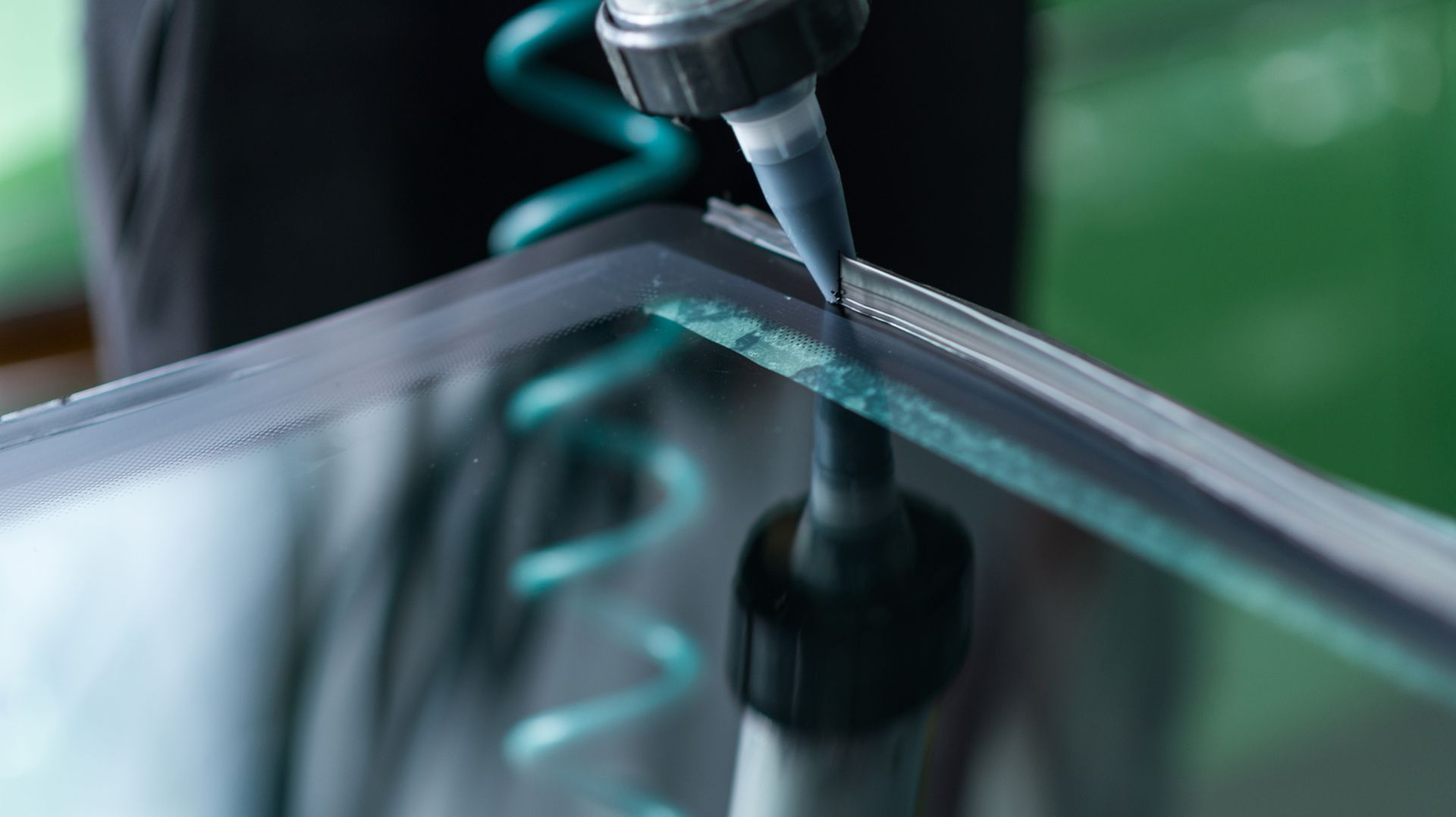 A Person Is Applying Glue to A Piece of Glass | Esk, QLD | ALSVET Windscreen Service