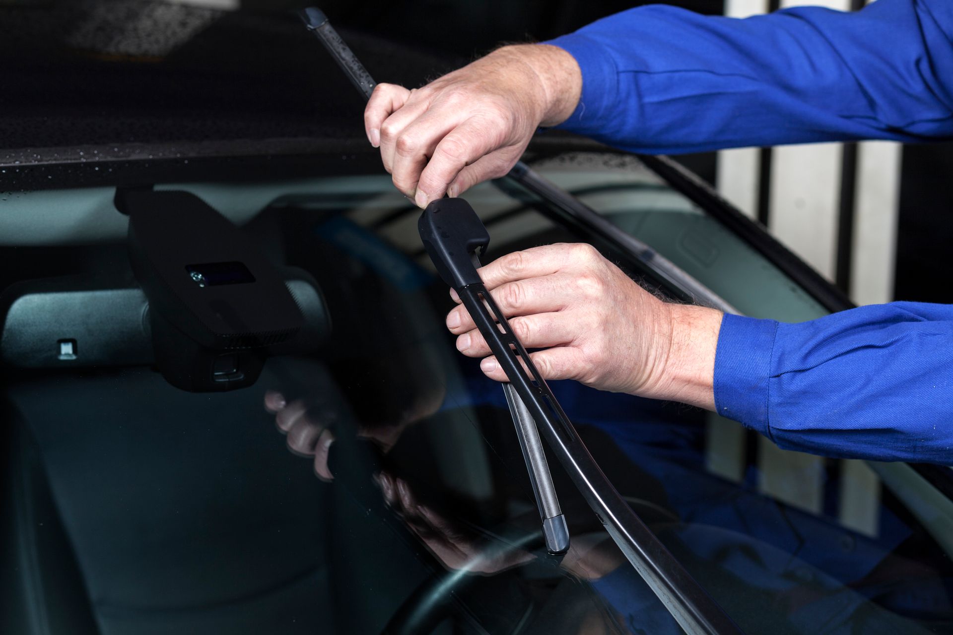 A Person in A Blue Shirt Is Fixing a Windshield Wiper | Esk, QLD | ALSVET Windscreen Service