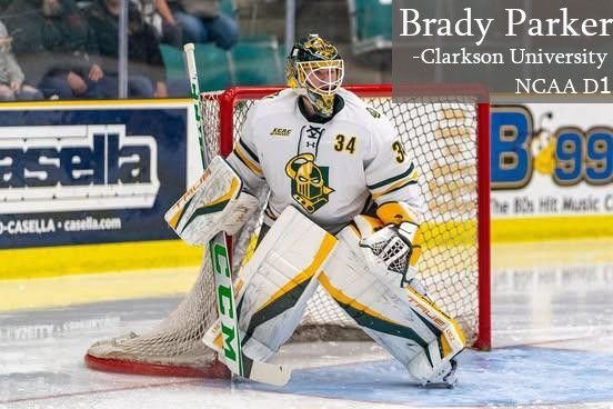 A hockey goalie in a white, green, and yellow jersey with number 34, crouching in front of a net on an ice rink.