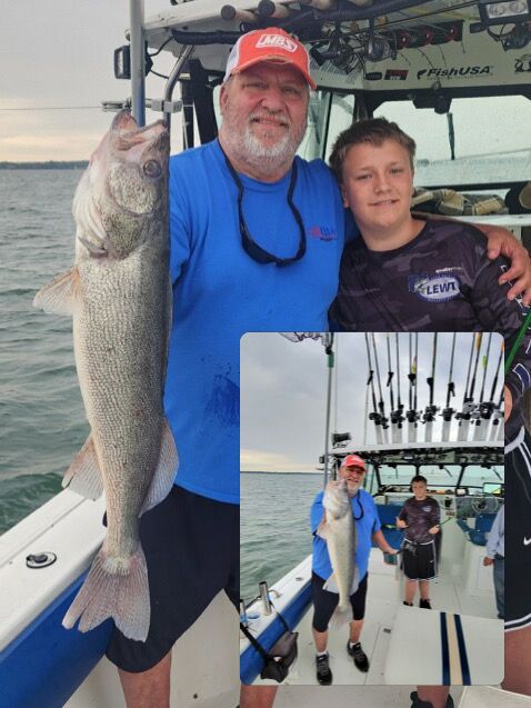 A man with his grandson holding a 29 inch Lake Erie walleye caught with Sir Walleye charters.