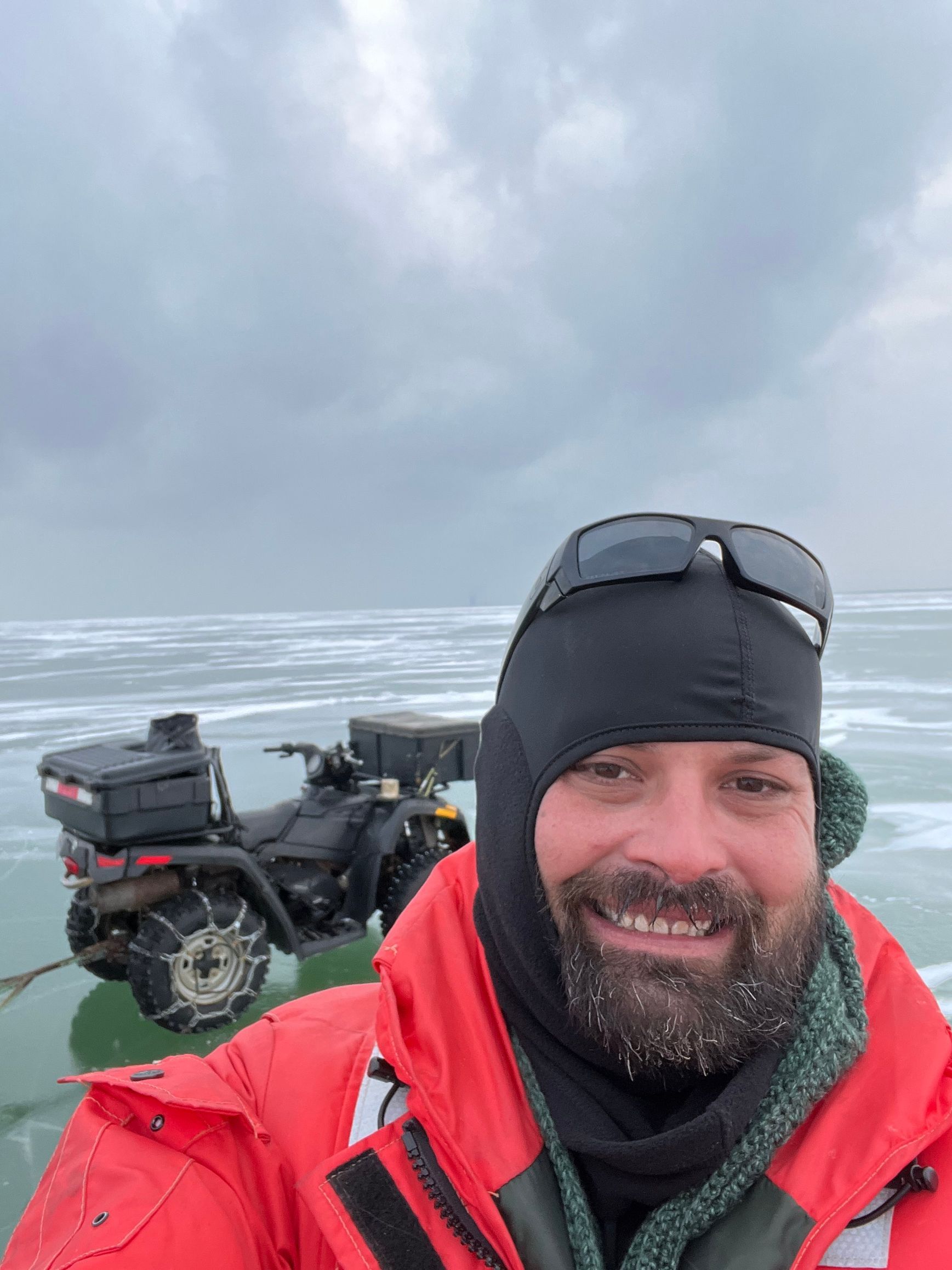 Standing on the ice in the middle of Lake Erie in a float suit getting ready to ice fish