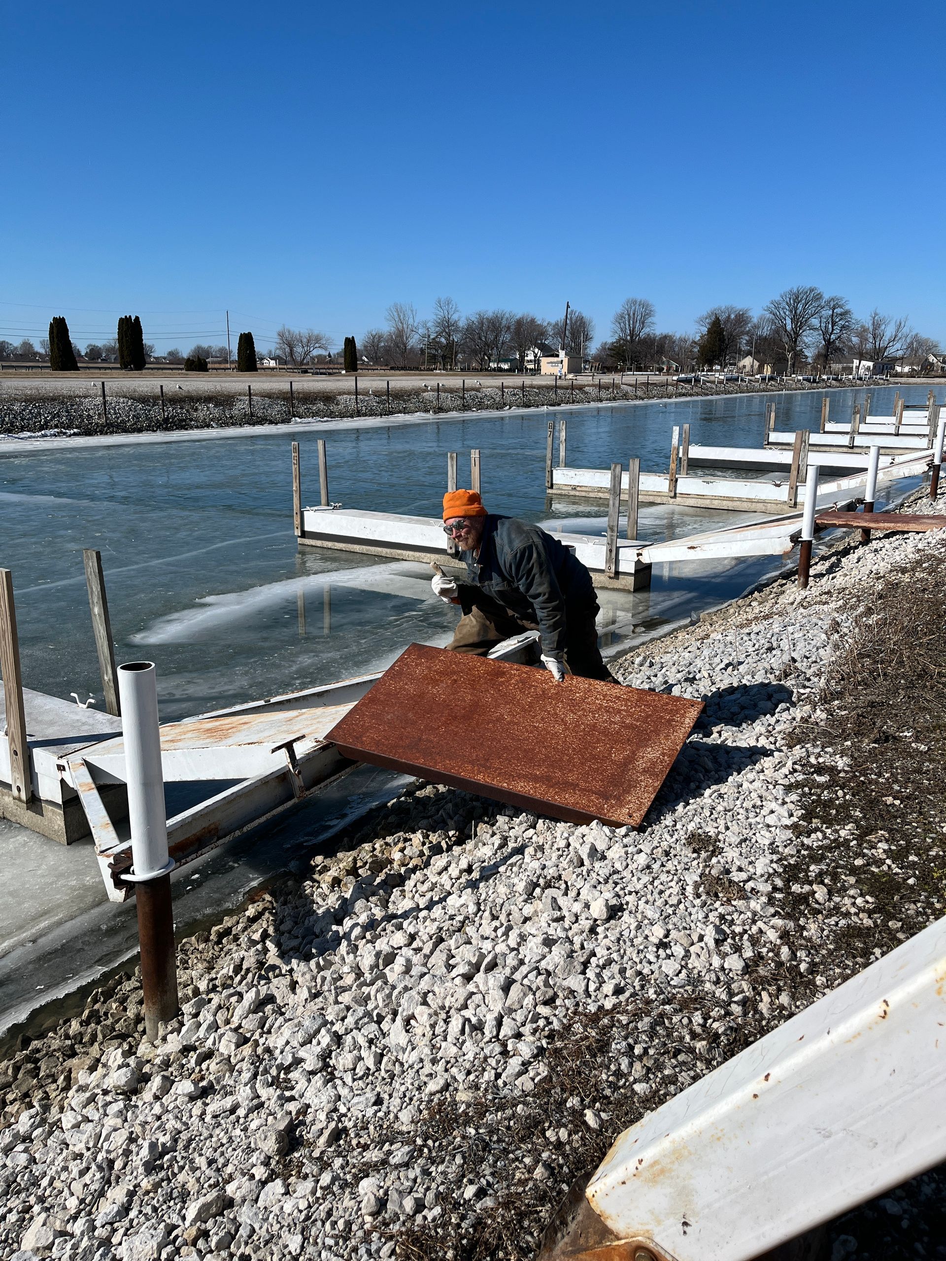 Wild Winds Marina in Western Lake Erie setting docks on the ice in preparation for 2026 season
