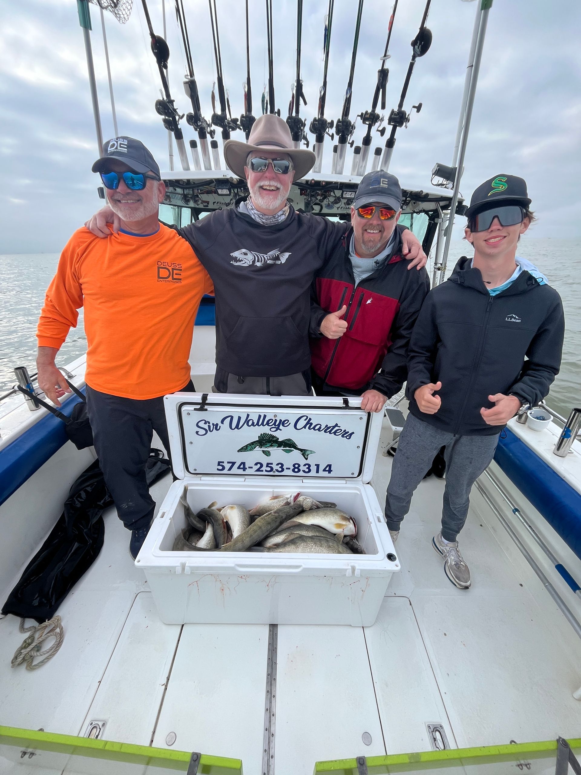 Group of Lake Erie anglers standing behind a cooler full of BIG Walleyes caught with Sir Walleye Charters! 