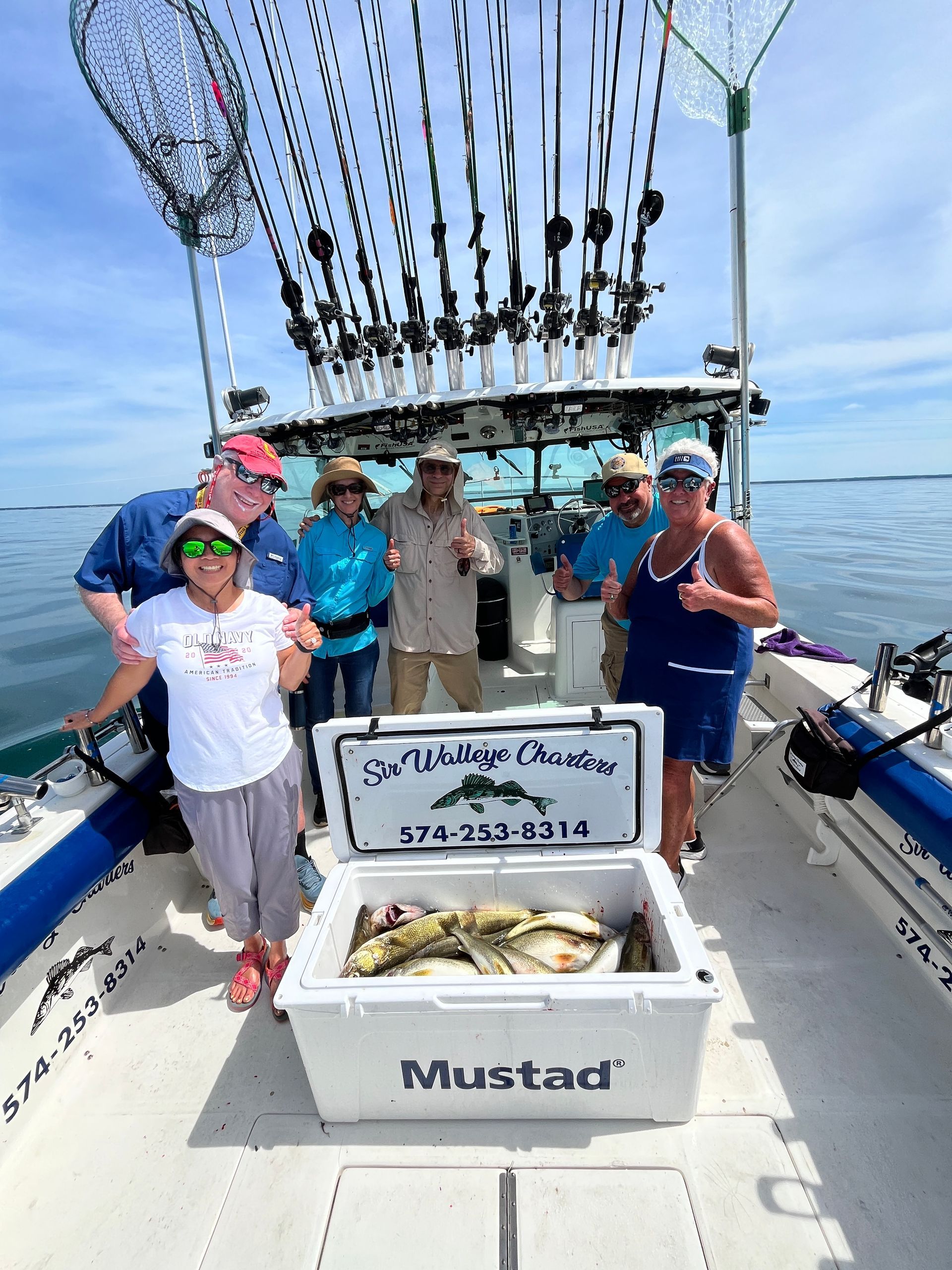 Group of friends with a cooler full of Lake Erie Walleye caught with Sir Walleye Charters.