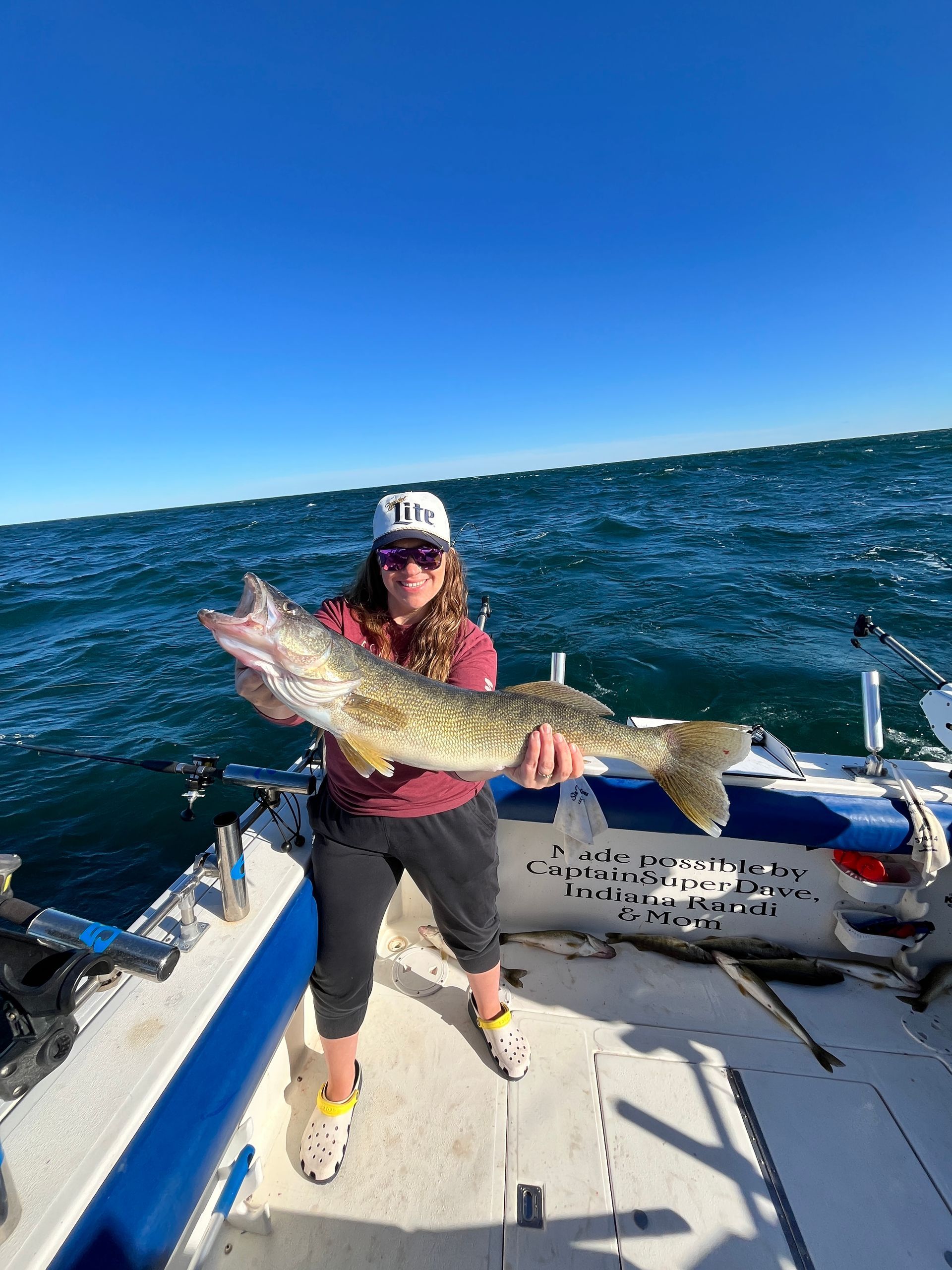 Women holds a 29 inch Lake Erie walleye Fish Ohio caught on the Sir Walleye Charters boat in Lorain, Ohio.