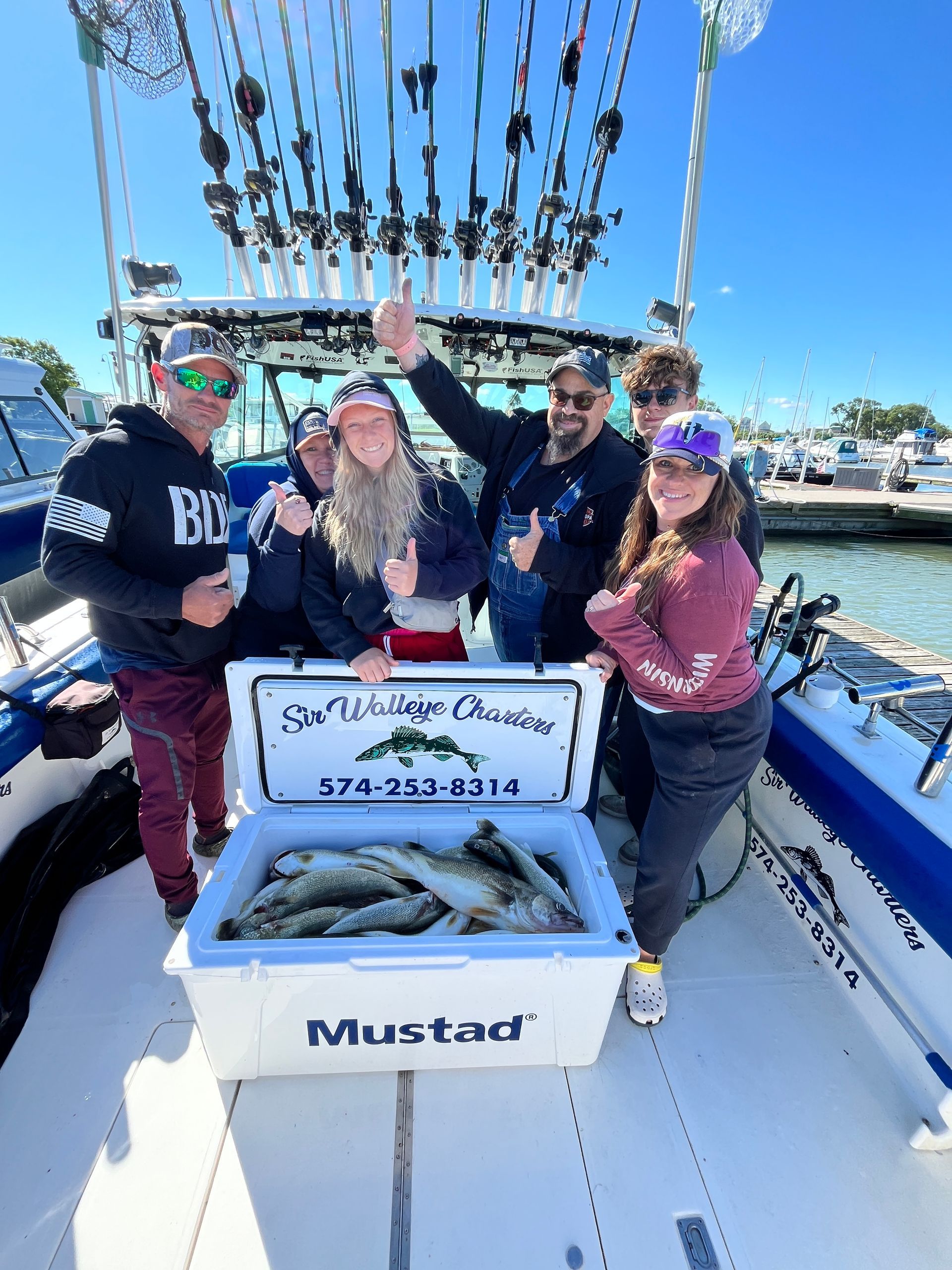 Family Lake Erie Charter group with a cooler full of walleye caught with Sir Walleye Charters.