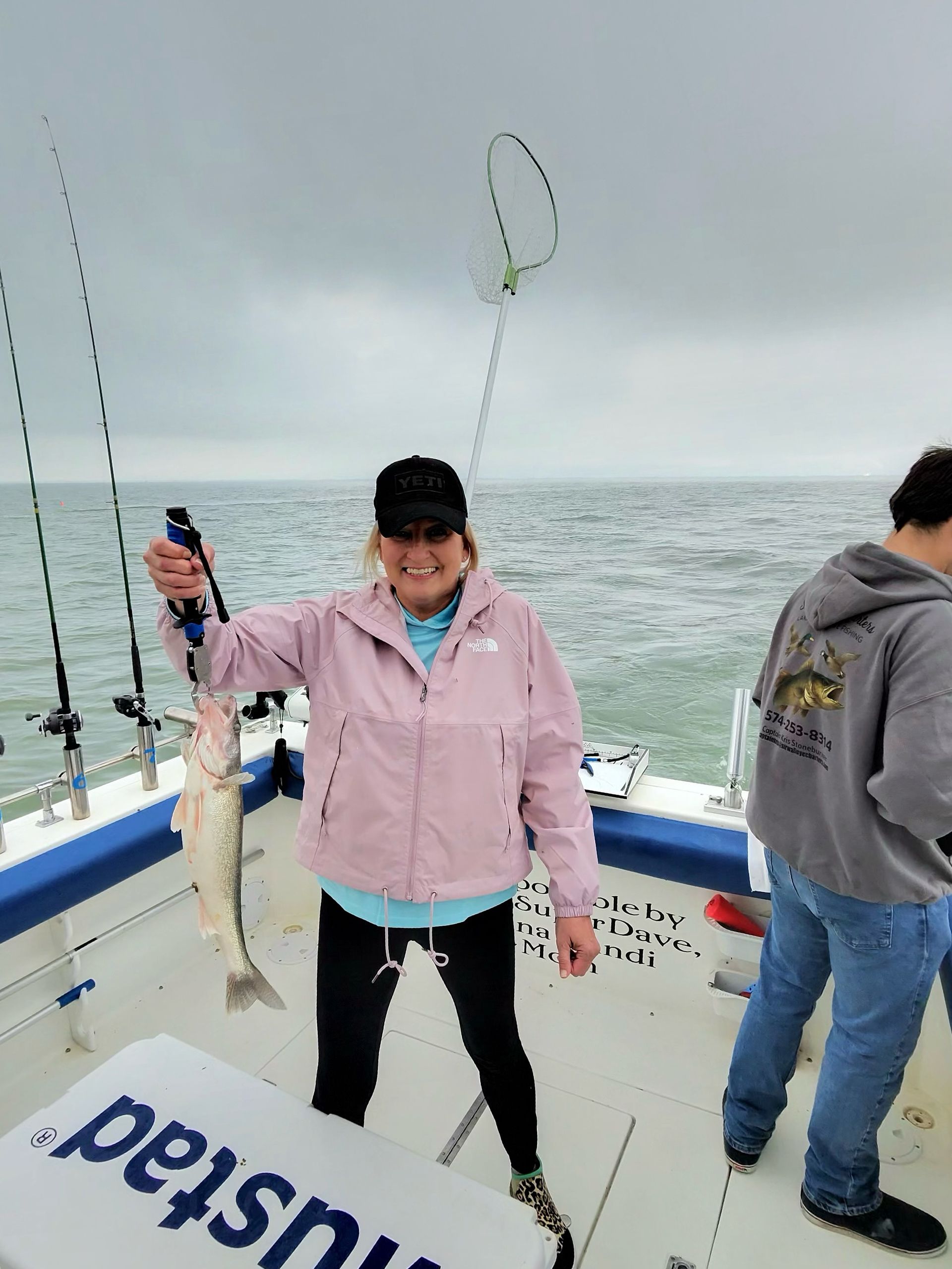 Women holding a Lake Erie Walleye caught on the Sir Walleye Charters boat. 