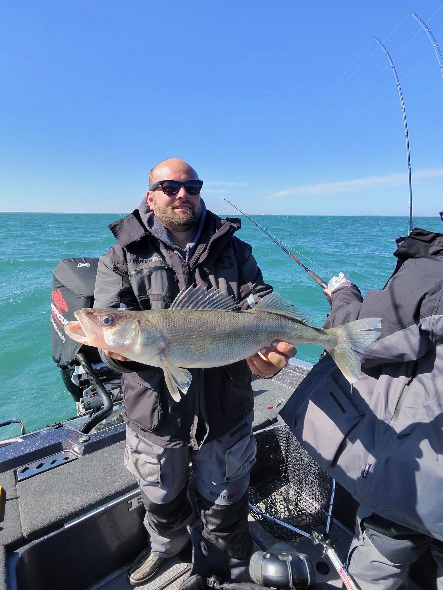 Captain Kris holding a 7 pound walleye on a Lake Erie fishing charter 