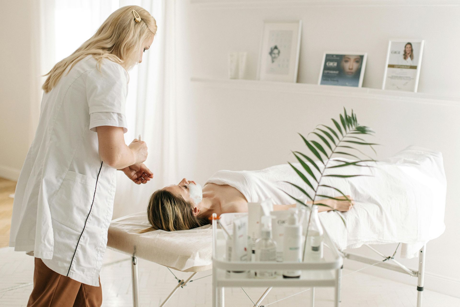 A woman is getting a facial treatment at a spa.