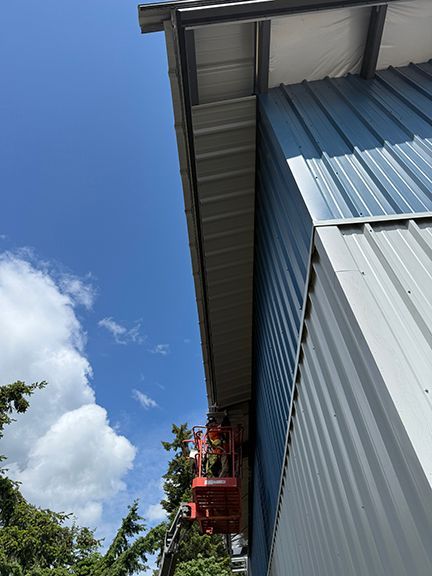 Soffits being added under metal roof on Salt Spring Island, BC.