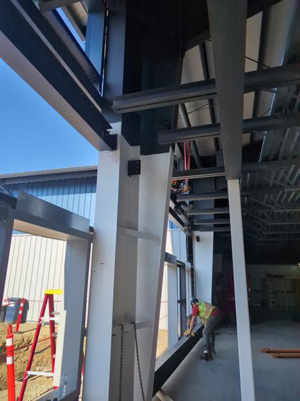 Closeup view of primary steel framing that supports wall and roof panels on PEMB project.