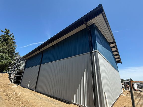 Exterior view of the blue and grey metal building wall panels in BC.