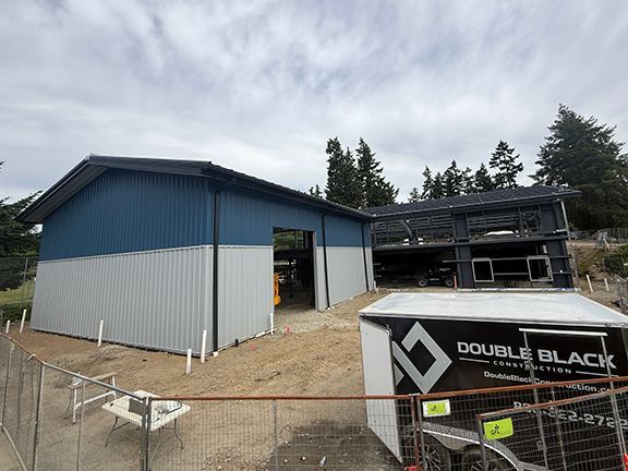 Construction photo showing beginning of building with steel framing behind.
