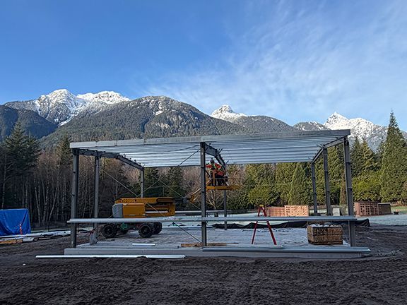 Nice view of steel building framing with mountains in background.
