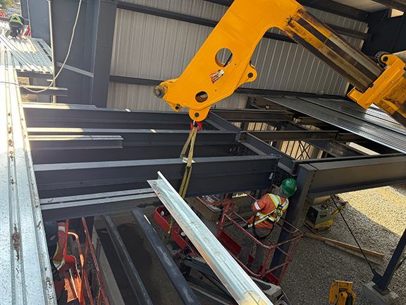 Metal support beam being lowered into place on Salt Spring Island project.