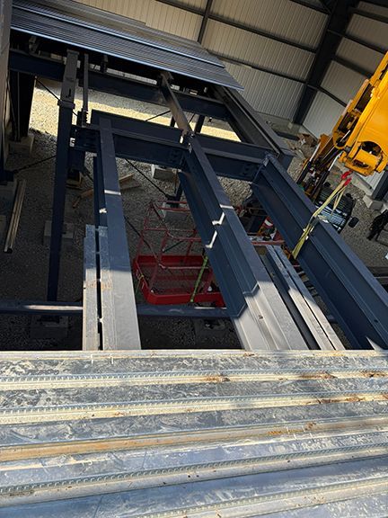 View of structural beams supporting mezzanine in Sal Spring Island building project.