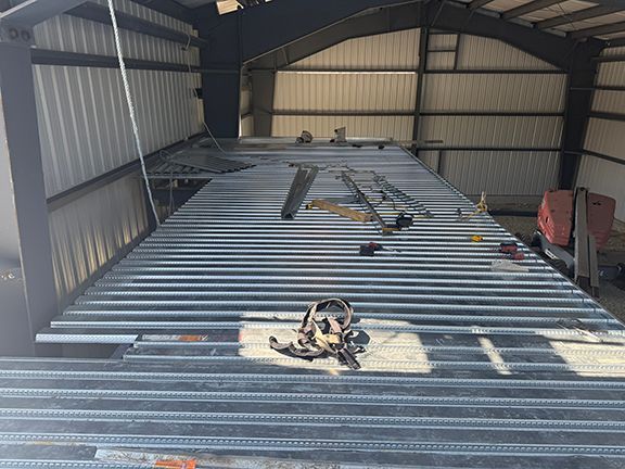 Metal floor supports being added to building mezzanine in Victoria Island construction project.