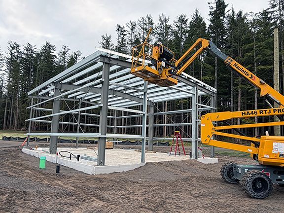 Roof frame being added to metal building construction in Squamish.