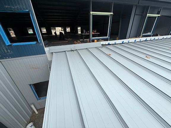 Closeup view of metal roof panels at Windsor Plywood project in Ganges, BC.