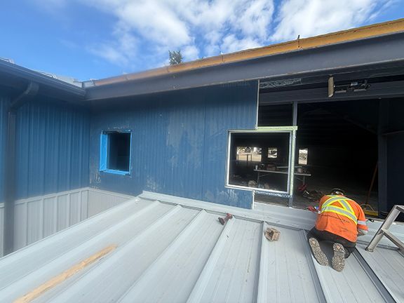 Metal wall panels and windows being added to project for Windsor Plywood.