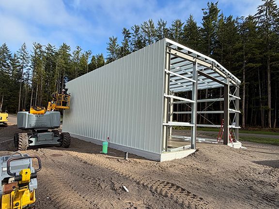Metal wall panels completed on one side of the building project.