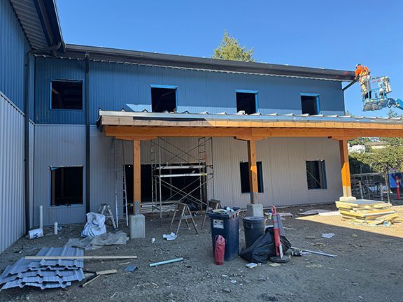 Exterior view of overhang being installed on metal building.