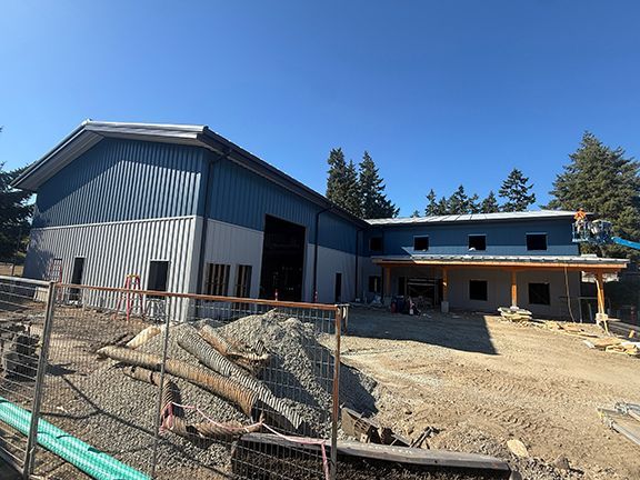 Unobstructed front view of metal building under construction in Ganges, BC.